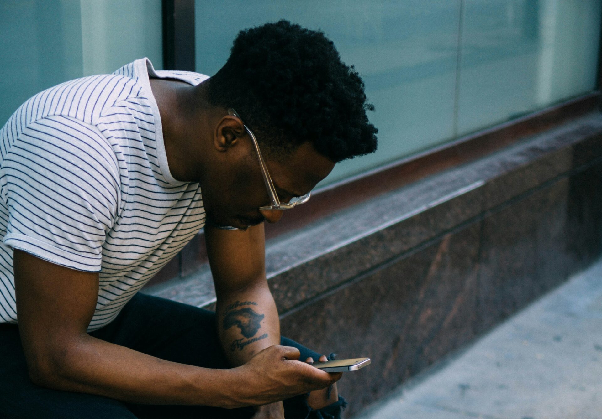 Photograph of a teenage boy using a smartphone