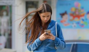 Photograph of girl using smartphone